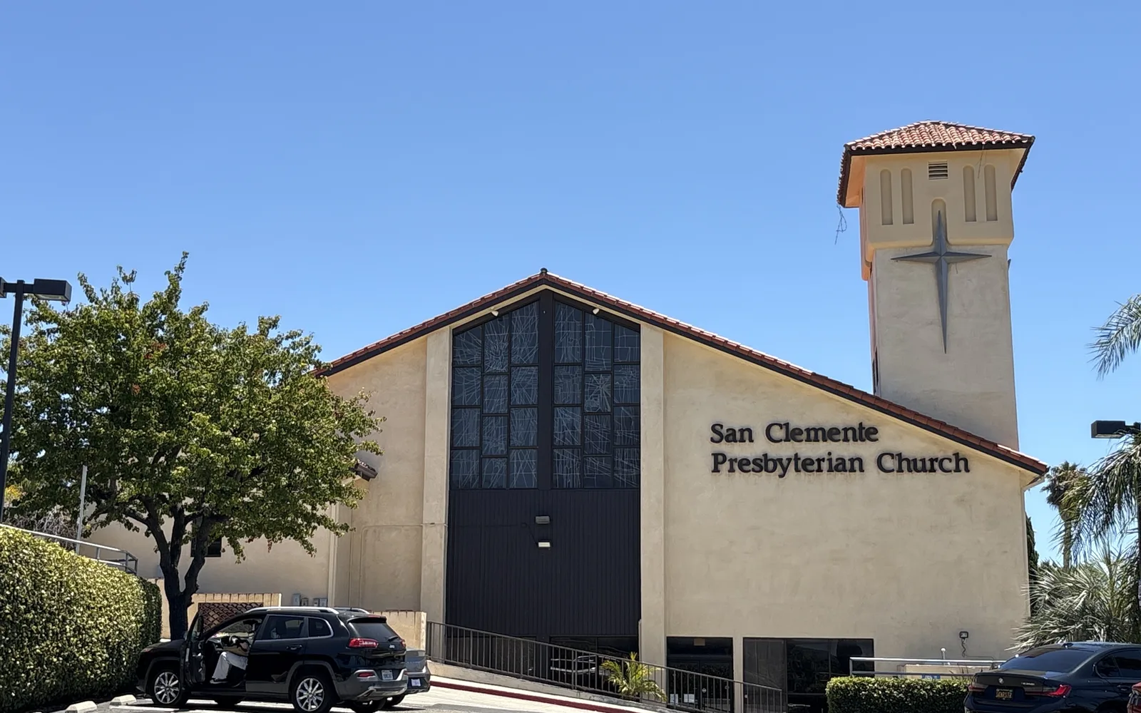 San Clemente Presbyterian Church with Spanish Colonial Revival architecture featuring cream stucco walls and red tile roof